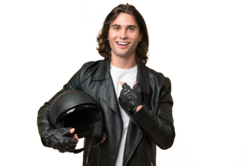 Young handsome man with a motorcycle helmet isolated on green chroma background with surprise facial expression