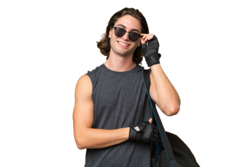 Young sport handsome man isolated on green chroma background with glasses and happy