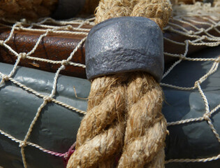 Fishing net close-up with gray lead weights attached. fishing boat top edge detail. fishing...