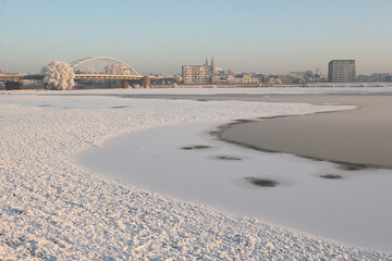 Fototapeta premium A view on the city of Deventer, the Netherlands, on a cold day with snow in winter 