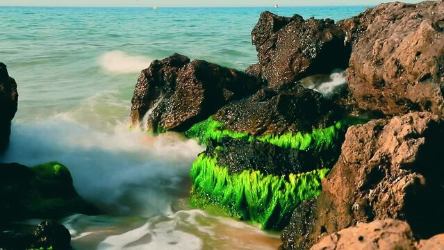 Waves hitting the rocks on the La Pineda beach in Salou Spain.