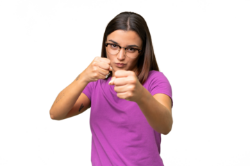 Young caucasian woman isolated on green chroma background with fighting gesture