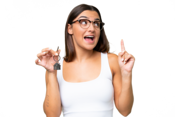 Young caucasian woman holding home keys isolated on green chroma background intending to realizes the solution while lifting a finger up