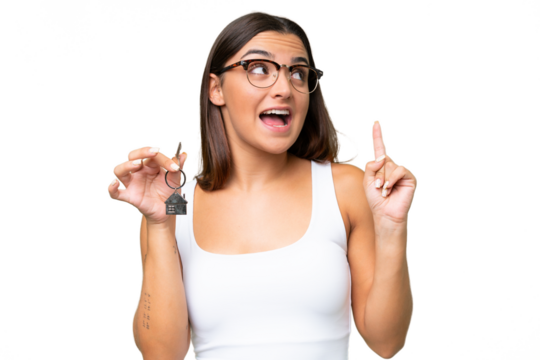 Young caucasian woman holding home keys isolated on green chroma background intending to realizes the solution while lifting a finger up