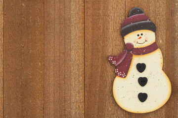 Snowman holiday background on weathered wood