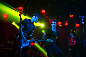 Electric guitar player performing at live show. Rock music artist at stage playing electric guitar.