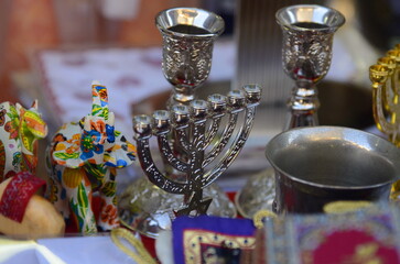Menorah, seven candles. Symbol of Hanukkah and the victory of light over darkness. Israeli souvenir on the market counter. 