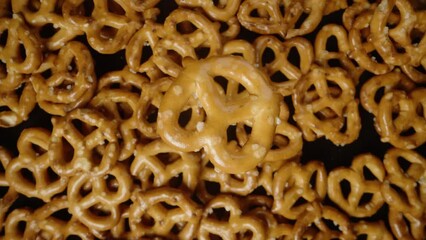 mini pretzel, slowly rotating top view. I'm taking one of a bunch of pretzels, top view.
