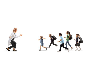 Group of children running towards a female doctor