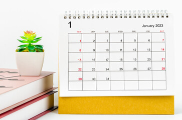 The January 2023 Monthly desk calendar for 2023 year with the books on white background.