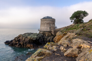 Martello tower and rocky coast on Howth island, Dublin, Ireland