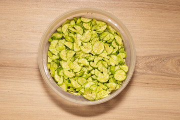 Maxixe sliced ​​with seed. Container on wooden table