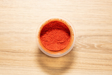 Paprika powder for seasoning. High quality photo on wooden table
