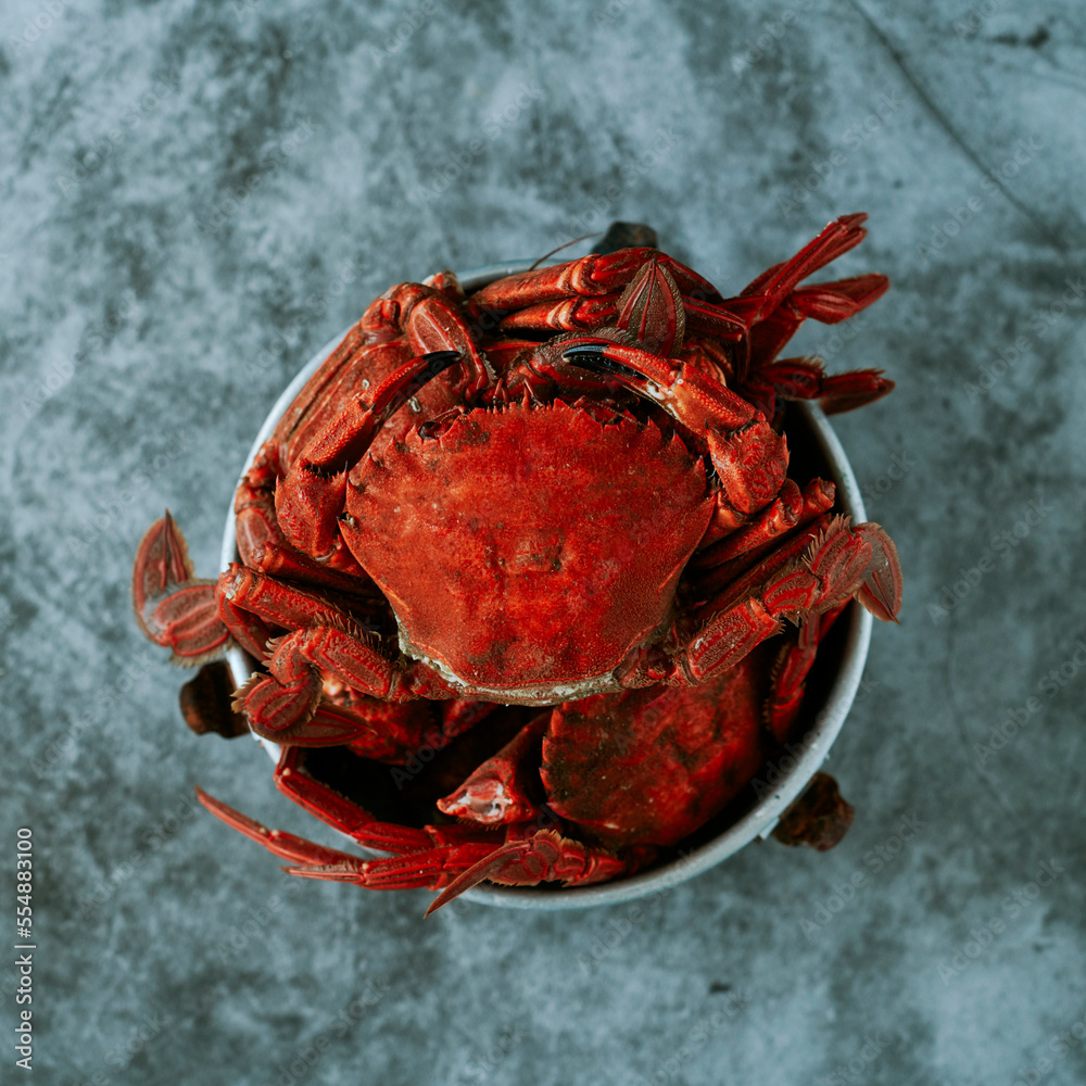 Wall mural some cooked velvet crabs in an old metal container