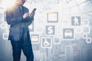The double exposure image of the business man standing back during sunrise overlay with cityscape image. The concept of modern life, business, city life and internet of things.