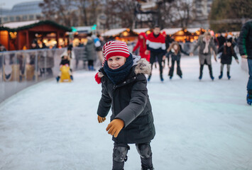 Boy skating on a rink at the Christmas market
