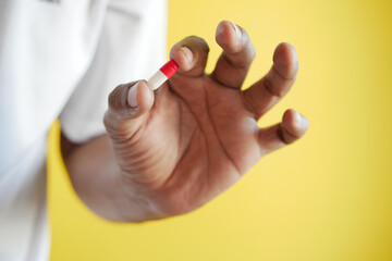 men holding a red and yellow color capsule 