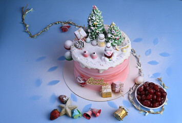 Christmas cake decorated with sweet figures of Christmas tree, Santa, bears, deer, fir-tree