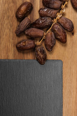 dates on slate cutting board on wooden table