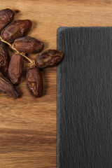 dates on slate cutting board on wooden table