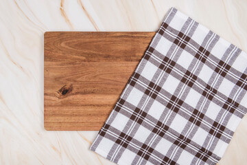 wood table on marble background with checkered cloth