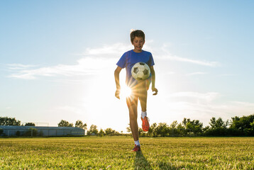 Soccer player kicks ball in a field