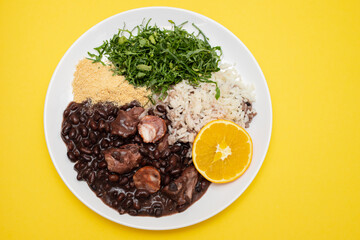 black beans stew with sausages on a white dish