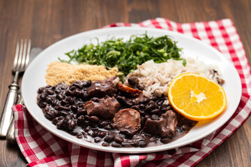 black beans stew with sausages on a white dish