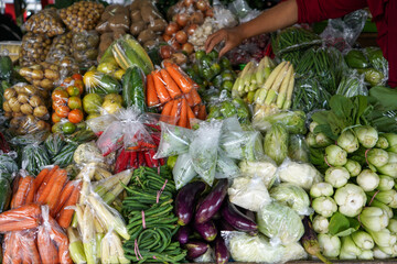 Many eggplants, tomatoes, potatoes, carrots, cucumbers, chilies, red chilies, corn, onions, avocados, chayote, green beans, long beans, garlic are sold in Bandungan Market, Semarang,  Indonesia.