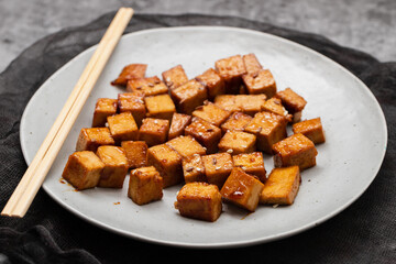 crispy deep stir fried tofu cubes on small dish
