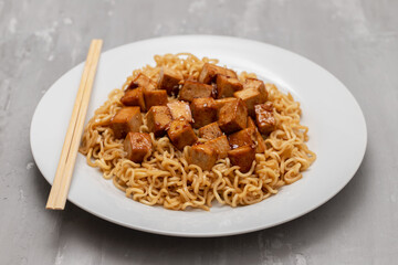fried noodles with tofu on white dish