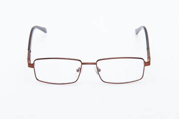 A spectacles copper color frames on white background.