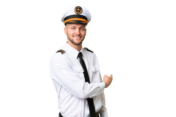 Airplane pilot man over isolated background pointing back