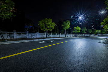 Empty asphalt road and street lights scene at night