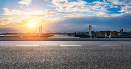 Fototapeta na wymiar Asphalt road and bridge with city skyline at sunset in Zhoushan City, Zhejiang, China.