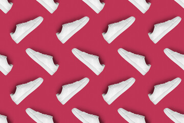Pattern of white sneakers isolated on magenta (Viva Magen) background. Sportive pair of shoes for mockup. Fashionable stylish sports casual shoes. Modern and minimalist wallpaper of fashion lifestyle.