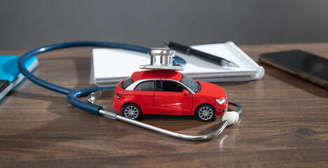 Stethoscope and car model on the table.