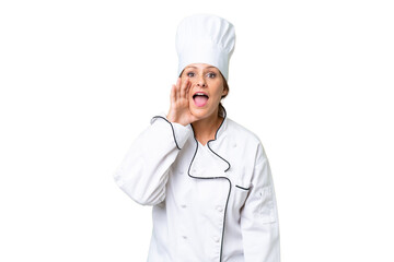 Middle-aged chef woman over isolated background shouting with mouth wide open