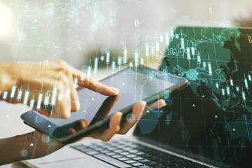 Multi exposure of abstract creative financial chart with world map and with finger presses on a...