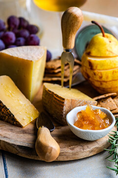 Different kinds of cheese, fruits and jams