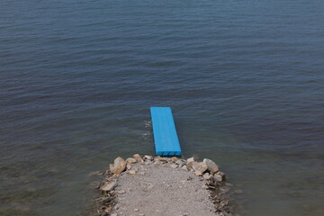 Pantone for swimming blue plastic by the water on the beach