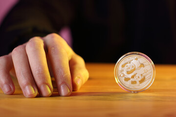 silver coin 10 yuan upright on the table next to the hand