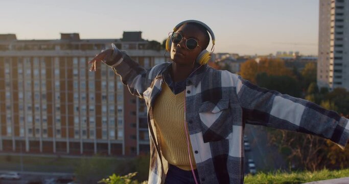 Young Black Woman Dancing on a Roof in Urban Area