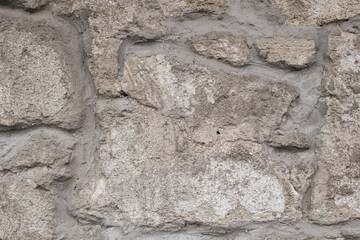 A wall of old stone cemented together. Background, texture