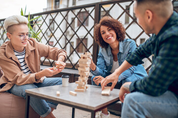 Company of three involved in a board game