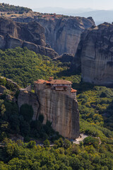 The Monastery of St. Barbara or Roussanou among mountains. Meteora, Kalambaka, Greece. Famous Greek orthodox christian shrine, unique rock formation, Unesco world heritage site. Travel, vacation.