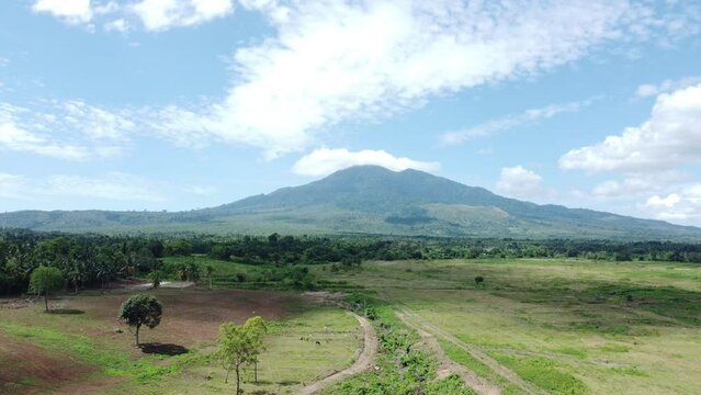 The view from the drone of Mount Seulawah Agam, green expanse of grass and trees.