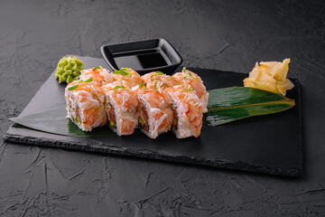 Fresh sushi rolls with shrimp on a stand with soy sauce