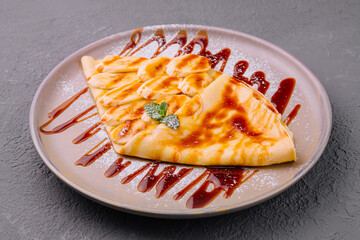 pancakes with banana and strawberry jam on a plate