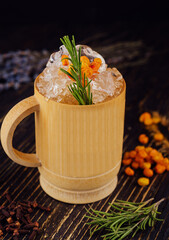 Fresh cocktail with sea buckthorn, juice, rosemary and ice